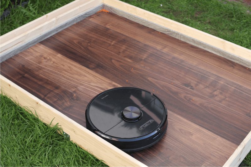 Robot vacuum in the test arena after completing the lentil suction test.